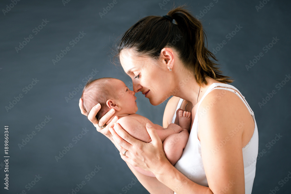 Canvas Prints Young mother, kissing and hugging her newborn baby boy