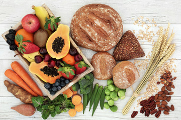 High fibre health food concept with fresh fruit, vegetables, wholegrain bread, nuts and cereals....