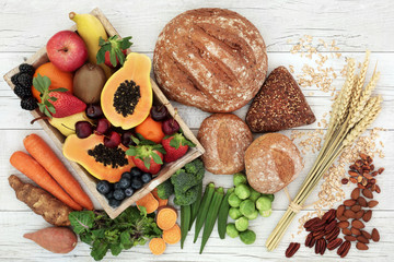 High fibre health food concept with fresh fruit, vegetables, wholegrain bread, nuts and cereals. Foods high in antioxidants, anthocyanins, omega 3 fatty acids and vitamins.   © marilyn barbone