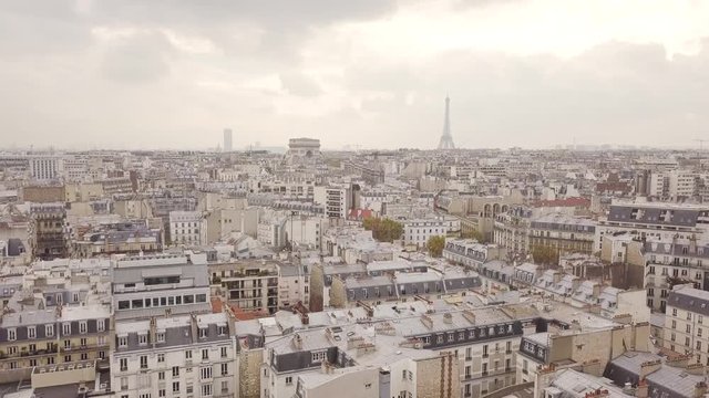 Flying above roofs of Paris in cloudy weather