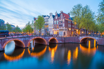 Naklejka premium Bridge over Emperor's canal in Amsterdam, The Netherlands at twilight. HDR image