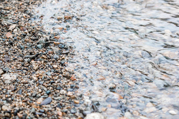 Sand and pebbles. Wave on a river, the sea.