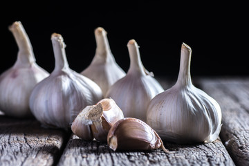 Organic garlic whole and cloves on the wooden background