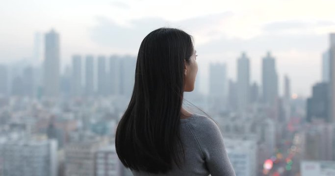 Woman thinking over the city background