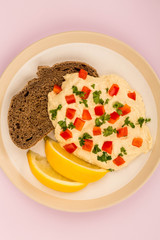 Vegetarian Snack of Hummus with Red Peppers Parsley Lemon and Rye Bread