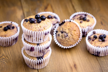 Tasty Muffin Cupcakes with Blueberries on a Wooden Background Pile of Homemade Muffins Horizontal