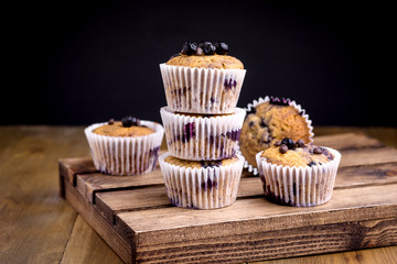 Tasty Muffin Cupcakes with Blueberries on a Wooden Background Pile of Homemade Muffins Horizontal