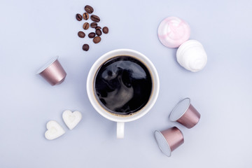 Top View Cup of Coffee Coffee Capsule Coffee Beans Sugar in Shape of Hearts Marshmallow Coffee Concept Background Blue Background Flat Lay