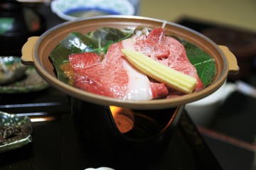 Japanese food specialty "Shabu shabu" with raw beef on a green leaf with corn