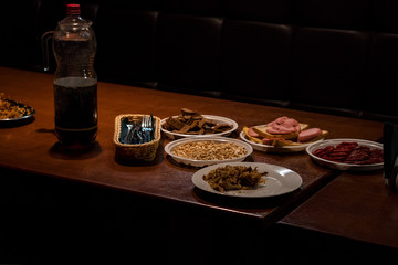 Plates with food on the table in a dark room