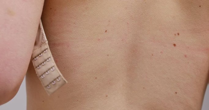 Woman taking off her bra