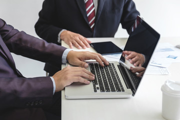 Teamwork process, Business team two managers colleagues discussing and analysis new plan financial graph data and marketing documents report on office table with laptop and digital tablet