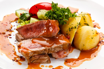 Grilled steak with vegetables on white background 