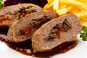 Stuffed meat, French fries and vegetables on white background 