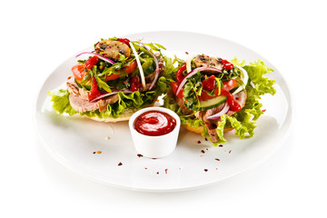 Sandwiches with meat and vegetables on white background 