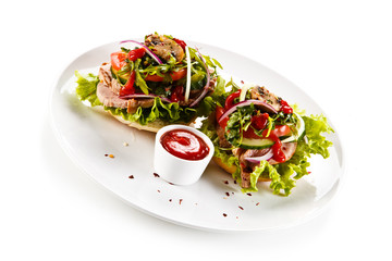 Sandwiches with meat and vegetables on white background 