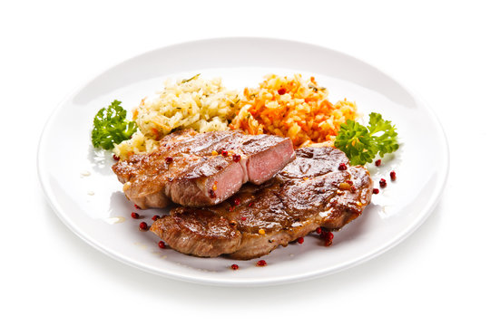 Grilled steak with vegetables on white background 