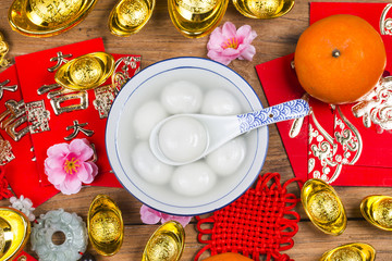 Chinese Lantern Festival food,ang pow or red packet and gold ingots. Chinese characters means luck,wealth and prosperity.