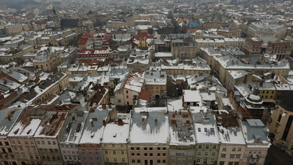 The landscape of the city center of Lviv from the city hall. The roofs are covered with snow.