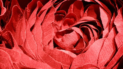 The texture of a bud of red flower made of paper.