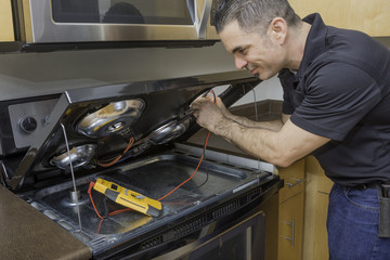 Electrician Checking a Stovetop Range