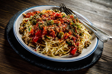 Spaghetti with meat, tomato sauce and herbs