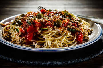 Spaghetti with meat, tomato sauce and herbs