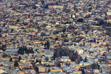 View of the city of Tbilisi, its tiled roofs and colorful houses from the viewpoint of the hill