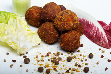 Fried meatballs with vegetables and spices