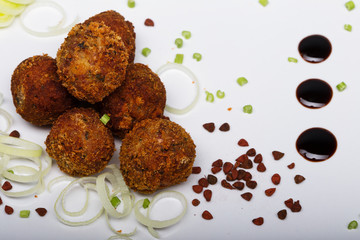Fried meatballs with vegetables and spices