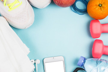 Sports shoes, dumbbell fitness in the blue background. Different sports tools