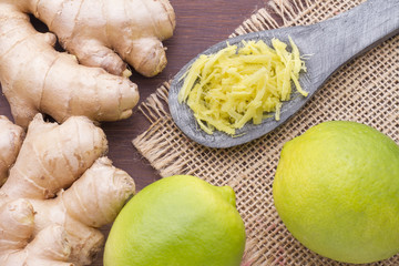 roots of ginger and lemon on wooden table