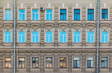Many windows in a row on the facade of the urban historic building front view, Saint Petersburg,...