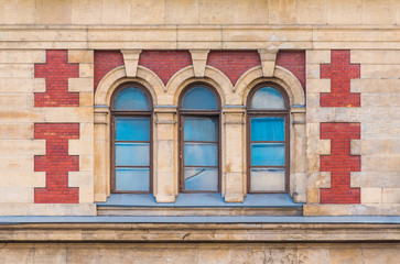 Three windows in a row on the facade of the urban historic building front view, Saint Petersburg, Russia
