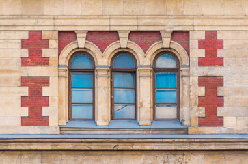 Three windows in a row on the facade of the urban historic building front view, Saint Petersburg, Russia
