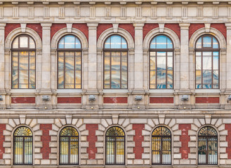 Several windows in a row on the facade of the urban historic building front view, Saint Petersburg, Russia

