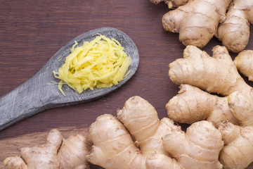 root and zest of ginger on wooden background