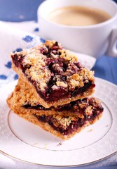 Blueberry bars with crumble topping and cup of coffee