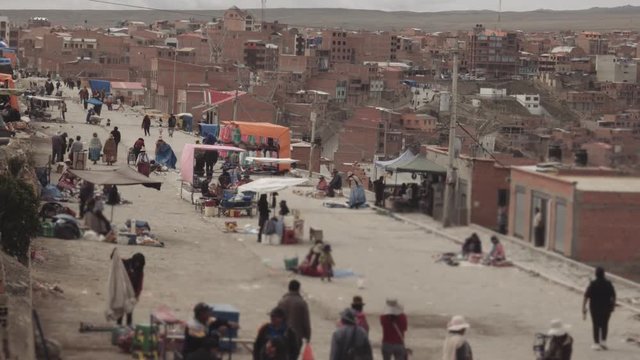 EL ALTO, BOLIVIA - CIRCA NOVEMBER 2017: People at street market walking around and watching merchandise during the traditional market of El Alto, Bolivia
