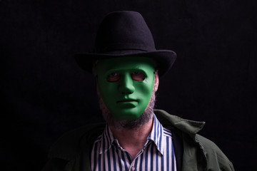 portrait of a man in a green mask