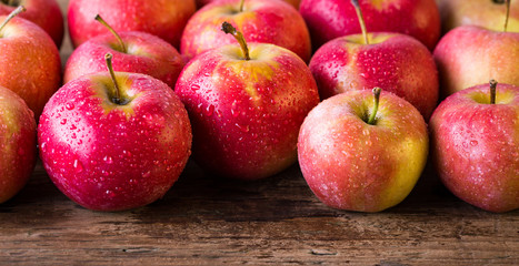 red apples on a wooden table, banner