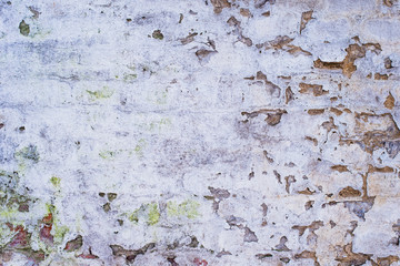 Ancient brick wall with remains of plaster - grunge background, texture