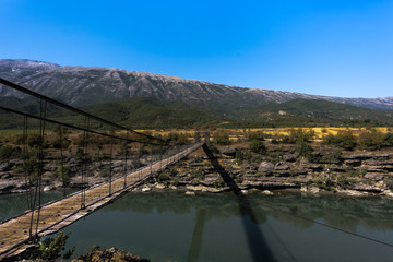  Connecting wooden bridge over River gorge embedded in beautiful albanian landscape, Albania
