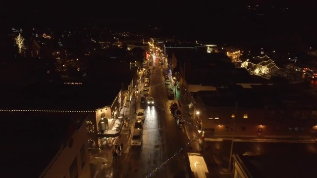 Aerial shot of small mountain town at night in the winter