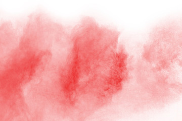 Red powder explosion on white background. Colored cloud. Colorful dust explode. Paint Holi.