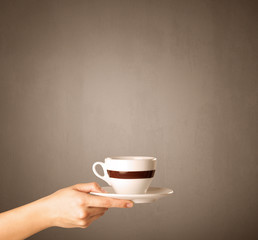 Female hand holding coffee cup
