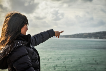 Tourist pointing at the sea