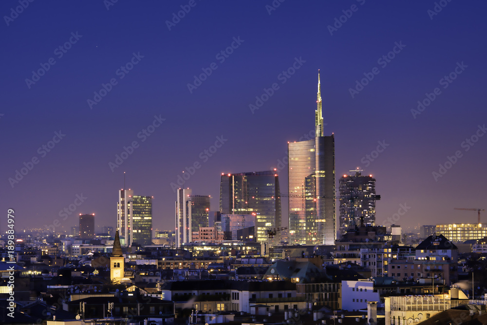 Wall mural milan skyline by night, new skyscrapers with colored lights. italian landscape panorama.