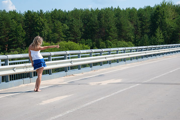 The blond girl is voting on the highway