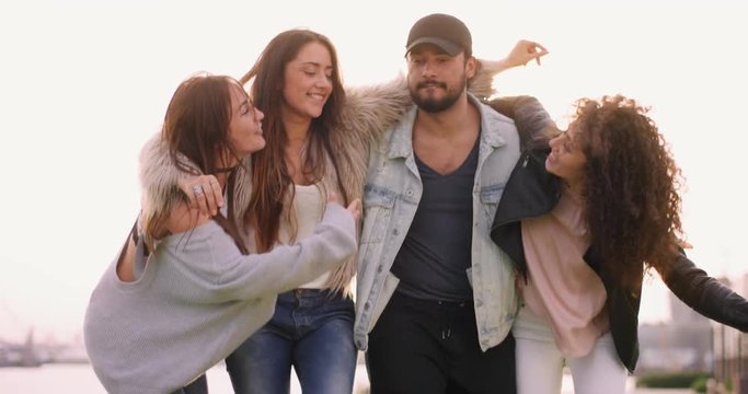 Four attractive young friends dancing and having a good time